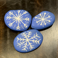 rocks with snowflakes painted on them