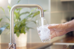 Picture of a glas of water being filled at a kitchen sink