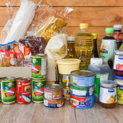 A pile of food and canned goods on a counter