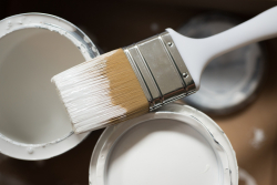 cans of paint and a paintbrush