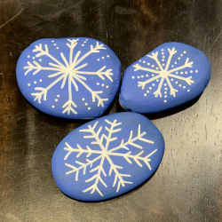 rocks with snowflakes painted on them