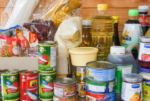 A pile of food and canned goods on a counter
