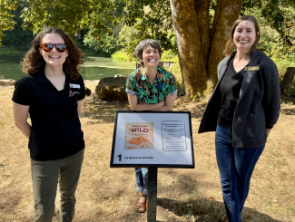 Margaux Meganck, author/illustrator of People Are Wild at the  StoryWalk with library staff