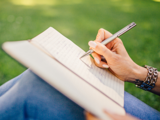 a person writing in a notebook