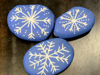 rocks with snowflakes painted on them